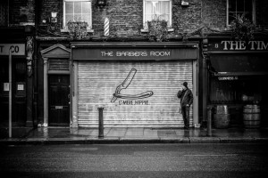 man outside barber shop-Philip Levine Kristen Dupard Discuss What Work Is