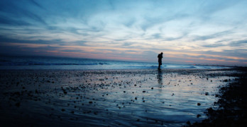 Dip into Poetry - silhouette walking on beach