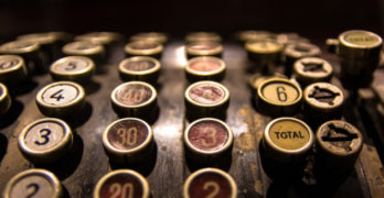 Vintage cash register top tax day haiku