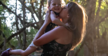 mother holding child into the air Motherload poem Kate Baer