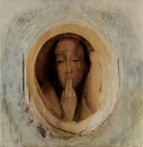 image of a woman with fingers pressed to her lips