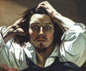 a distressed man running his hands through his hair