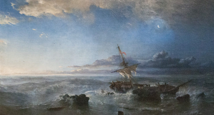 the light of dawn shines upon a shipwreck in calmer waters