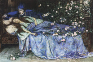 man leans over sleeping woman