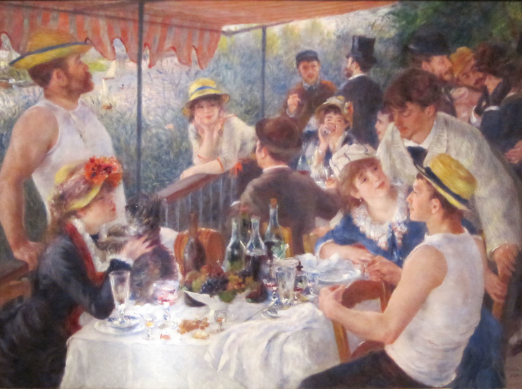 friends gather around on a boat sharing food and conversation 