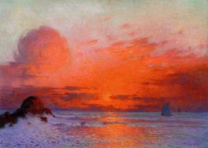 sunset on a beach with warm colors and bright reds and oranges