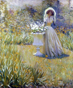 a woman in a white dress and thin veil stands by a garden pot with white flowers and she looks at the painter.
