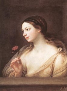 woman with braided hairdo holds a pink rose
