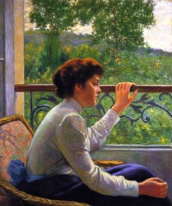 a woman looks out her window