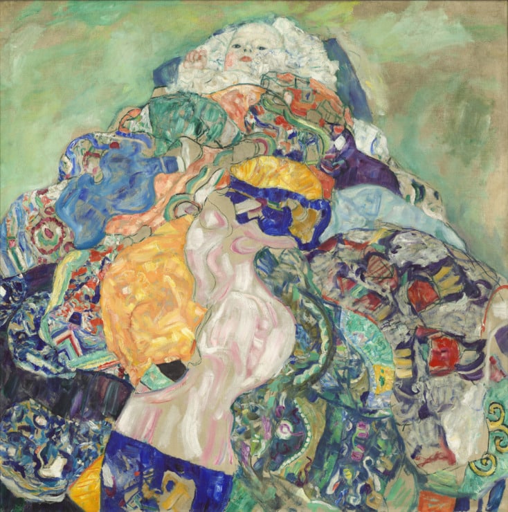 baby in a colorful cradle