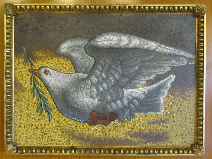 mosaic of a dove holding olive branch