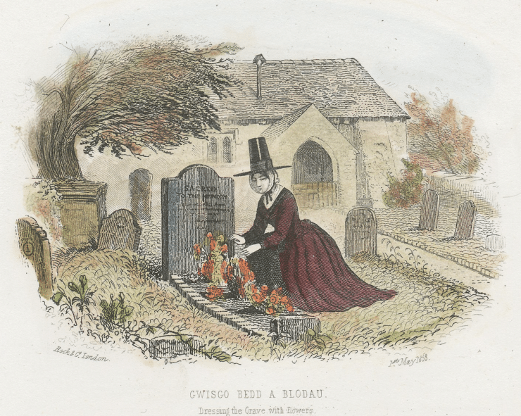 woman resting flowers on a grave 