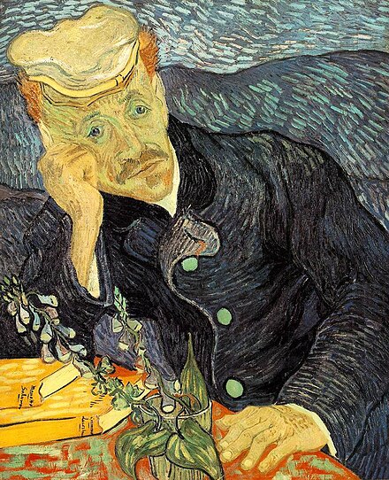 man sits with his hand on his face and elbow resting on a table