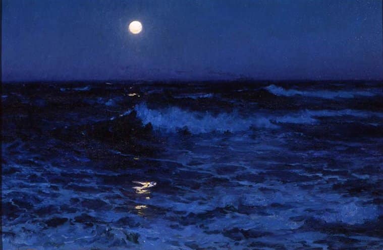 the moon glows over the ocean at night