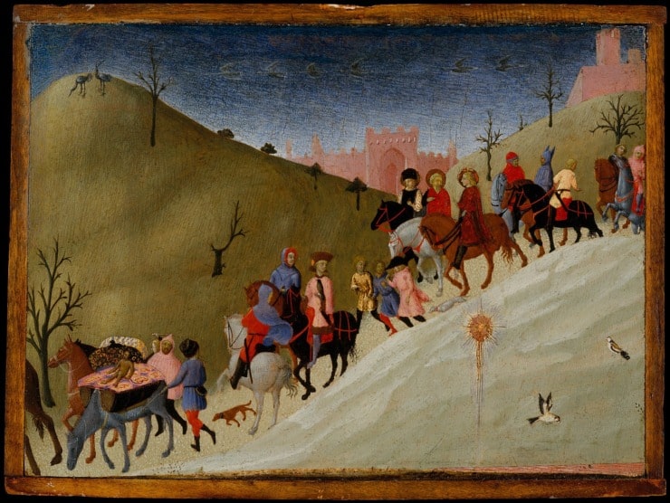 many people on horseback take a journey out of a city 