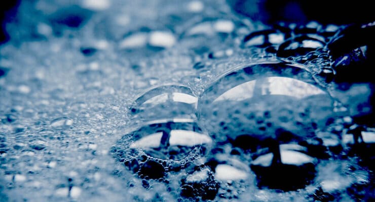 soap suds on dark surface