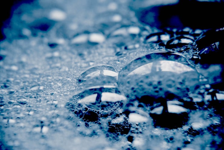soap suds on dark surface